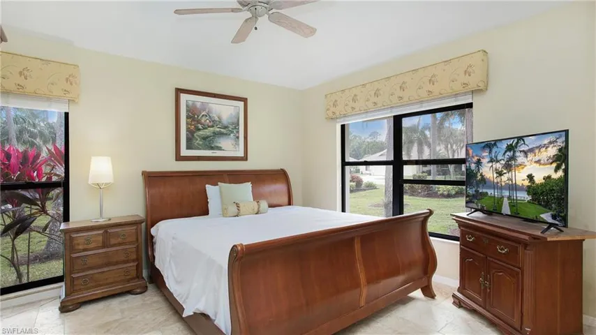 Bedroom with ceiling fan and multiple windows