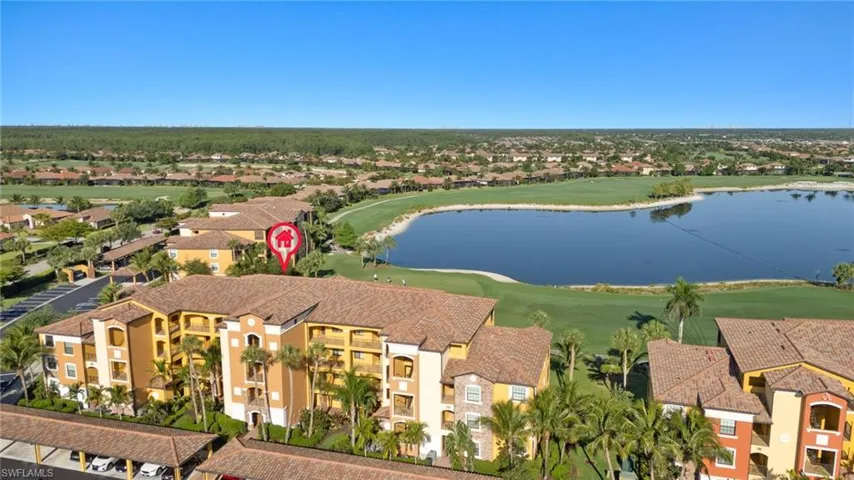 Aerial perspective of suburban area featuring a large body of water and a golf club