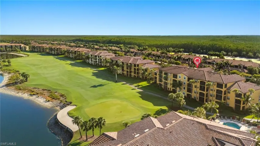 Aerial perspective of suburban area featuring a nearby body of water and a golf club