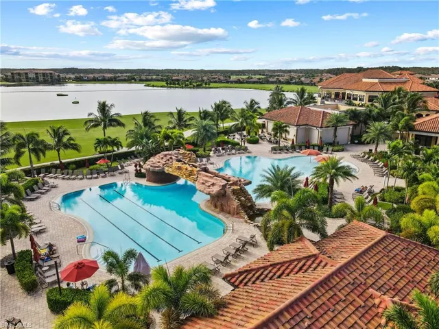 Community pool featuring a water view and a patio