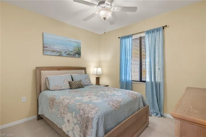 Bedroom featuring carpet, baseboards, and ceiling fan