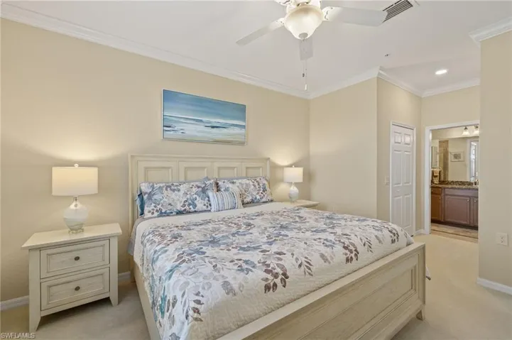 Bedroom with light carpet, baseboards, ornamental molding, connected bathroom, and recessed lighting