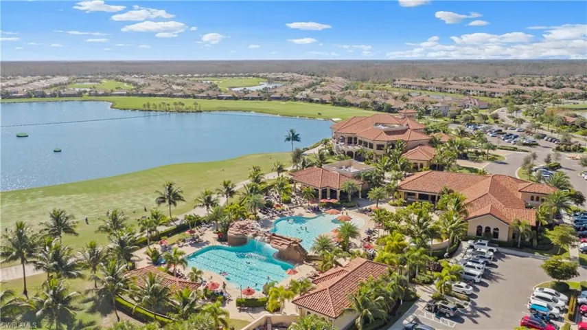 Birds eye view of property with golf course view and a water view