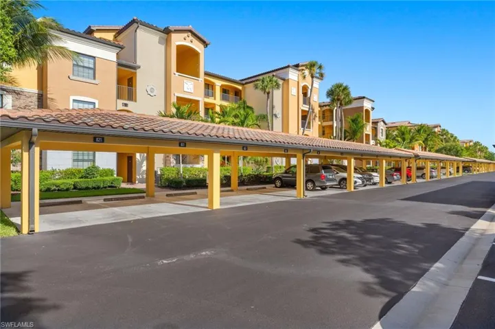 View of property featuring covered parking