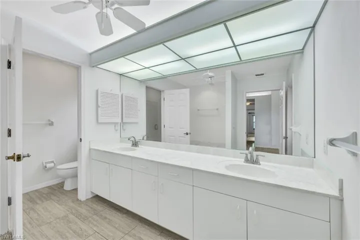 En-suite primary bathroom features dual sinks and a soaking tub.