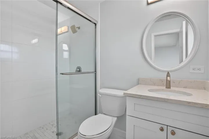 Full Master bathroom with vanity and a shower stall