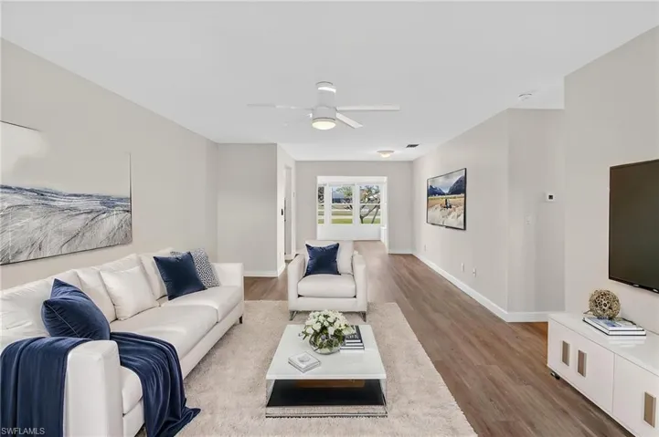 Living room featuring light wood-type flooring and ceiling fan