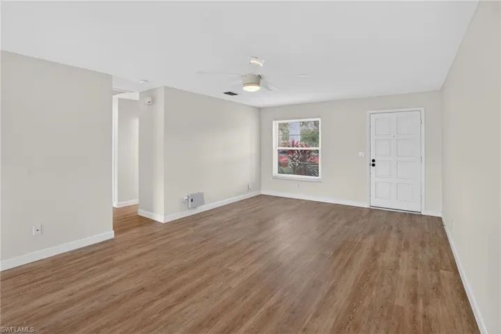Unfurnished room with a ceiling fan and wood finished floors