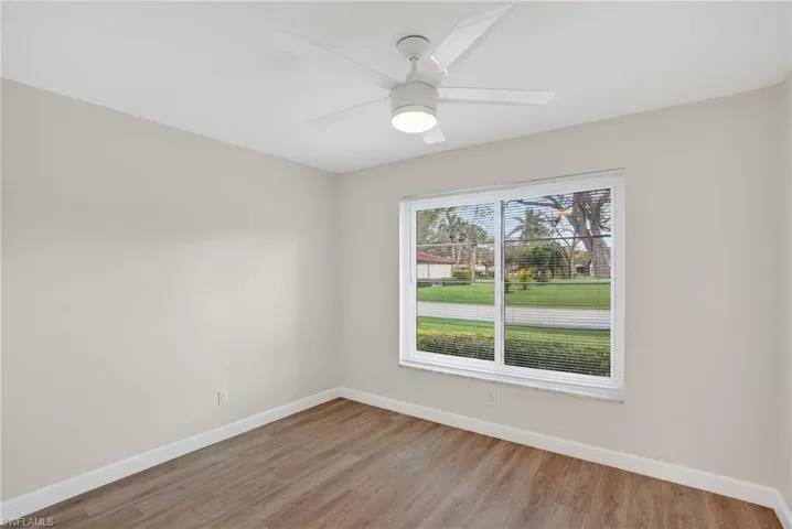 Guest room featuring light wood-style flooring and a ceiling fan