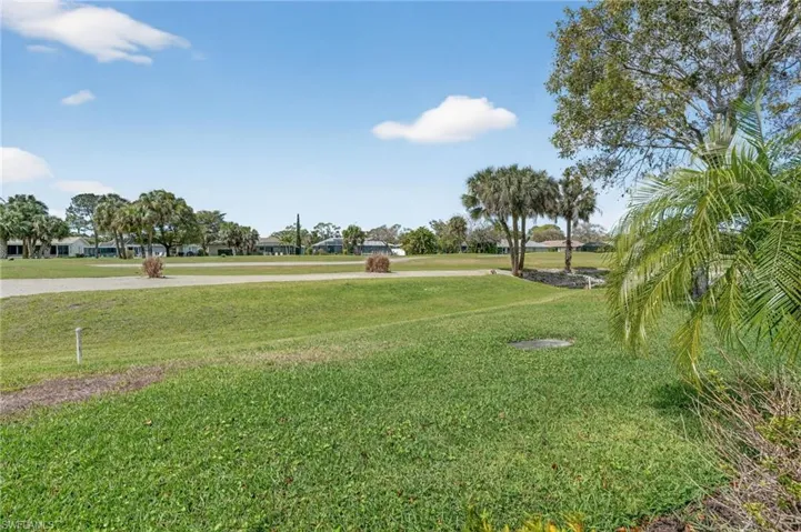 View of green lawn with golf course view