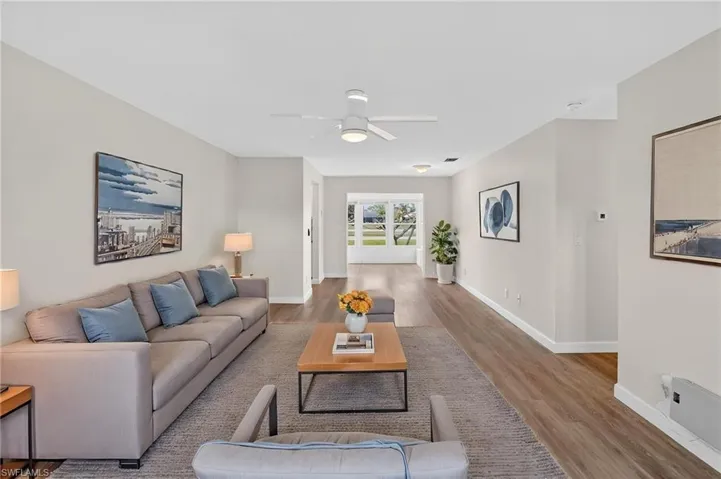 Living room with wood finished floors and a ceiling fan
