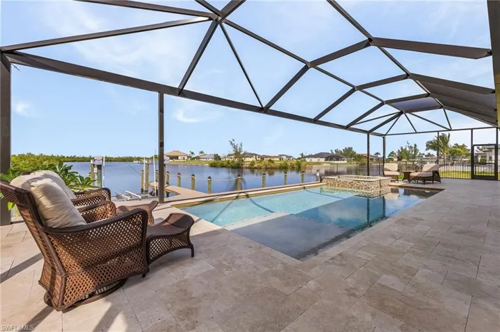 Pool and spa, screen enclosure, and view of canal