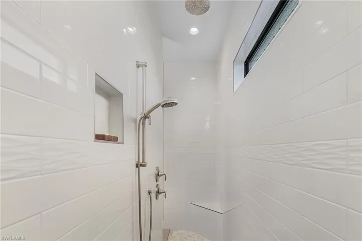 Tiled walk in shower with transom window