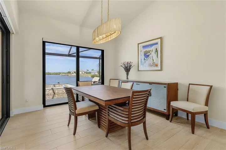 Dining room with access to lanai and pool, tile flooring, and chandelier light fixture
