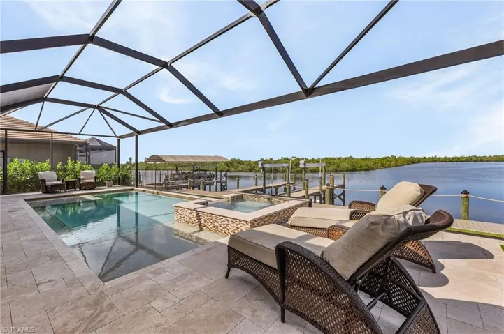 Pool and spa, screen enclosure, and view of canal