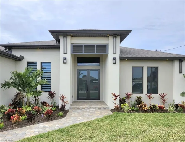 Doorway to property with french doors and a yard