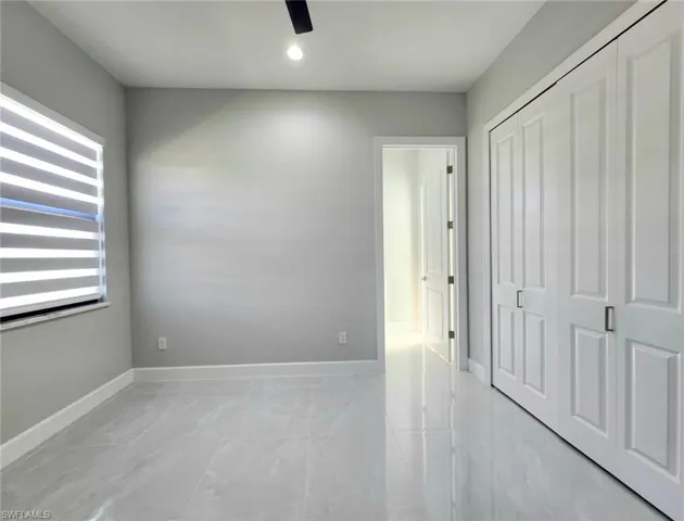 Unfurnished bedroom featuring a closet and ceiling fan