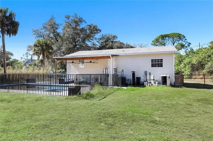 Back of house featuring ceiling fan and a patio