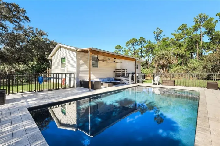 View of pool with a patio, outdoor lounge area, and a fenced backyard