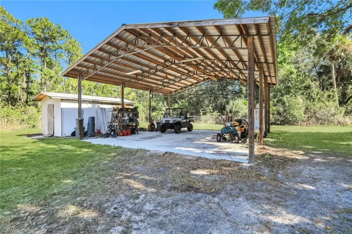 View of car parking featuring a detached carport