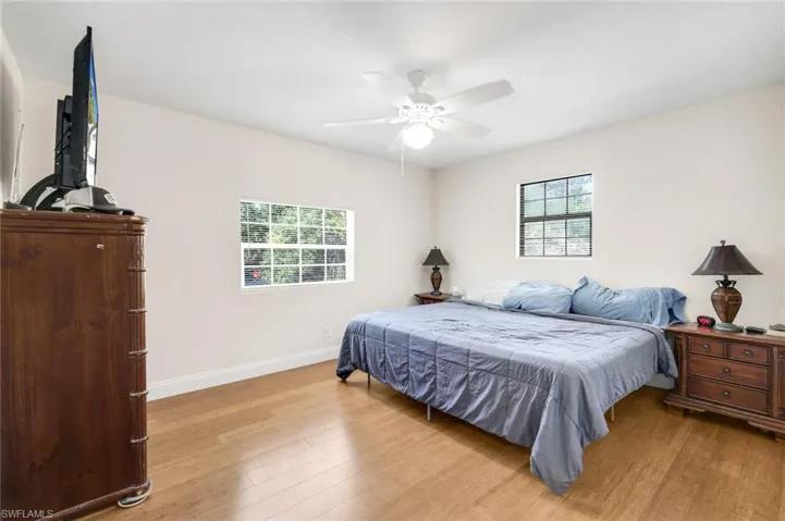 Bedroom with light wood-style flooring and ceiling fan