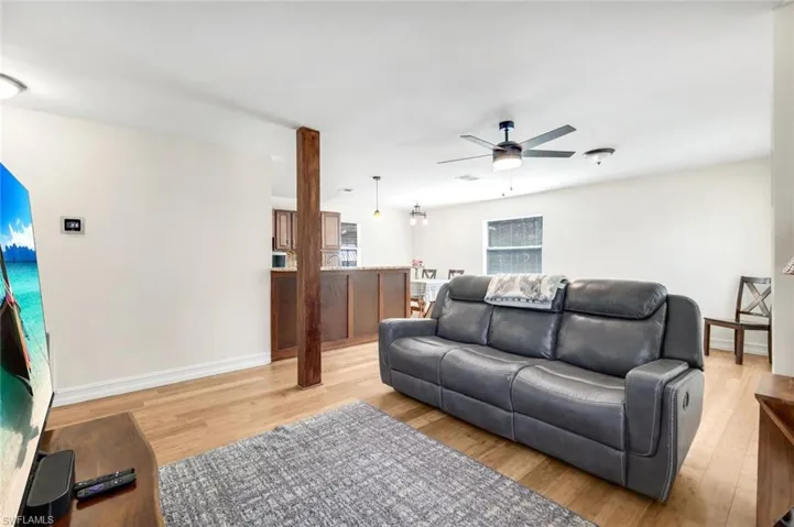 Living area featuring light wood-type flooring and a ceiling fan