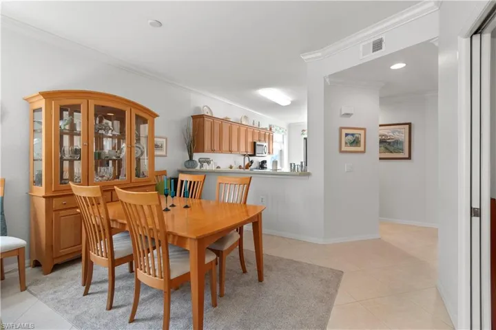 Dining area featuring crown molding and tile flooring