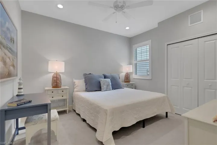 Bedroom with light carpet, recessed lighting, a closet, and ceiling fan