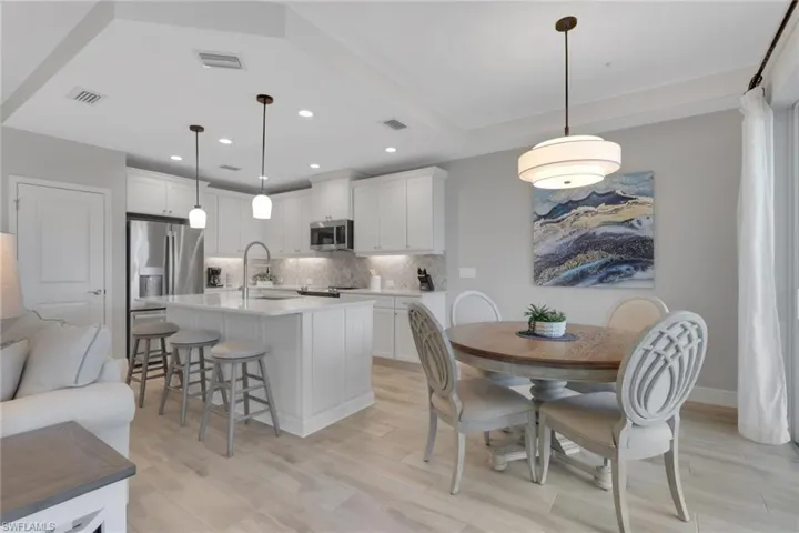 Dining area featuring light wood-style floors and recessed lighting