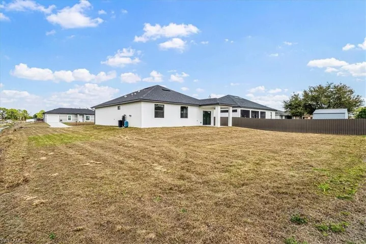 Rear view of property with stucco siding