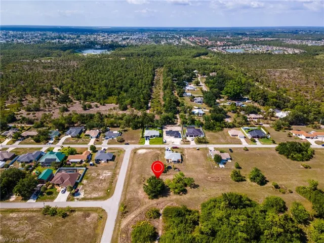 Aerial overview of property's location with a nearby body of water and nearby suburban area