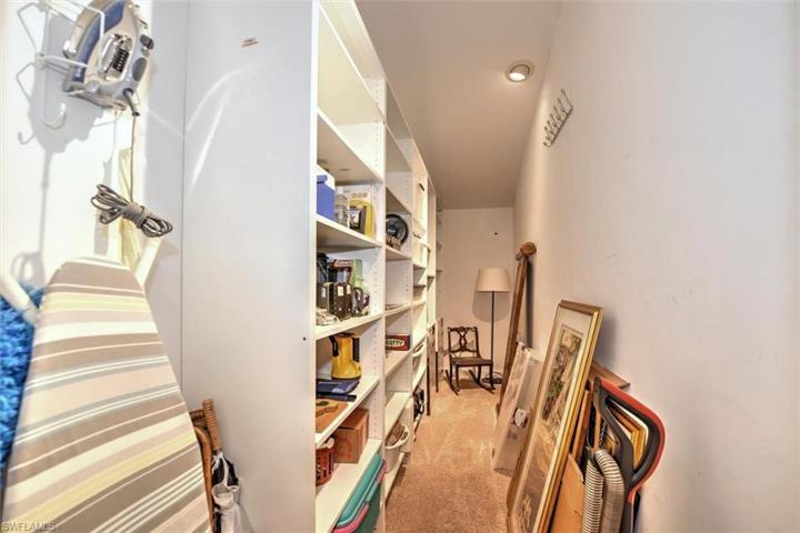 Large, walk in storage closet with built in shelving.