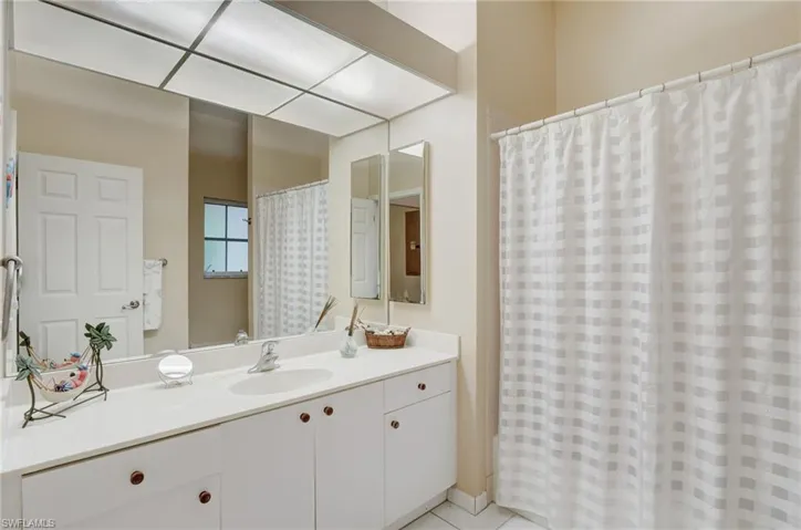 Bathroom featuring tile floors and vanity