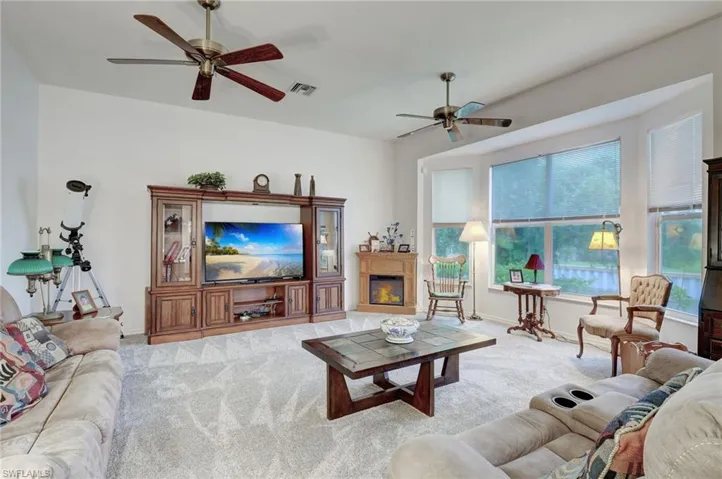 Newly Carpeted family room with ceiling fan