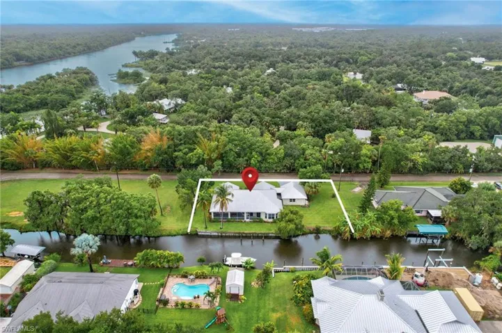 Birds eye view of property with a water view