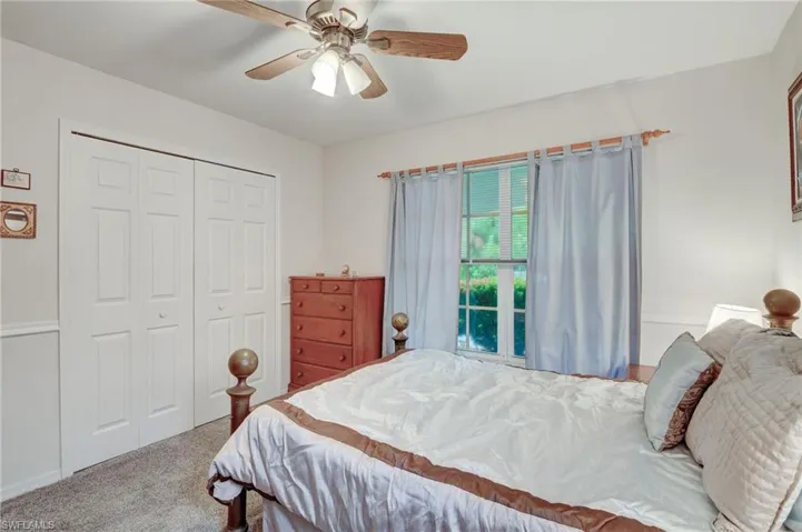 Bedroom featuring a closet, ceiling fan, and carpet floors