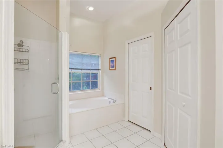 Bathroom with tile floors and separate shower and tub