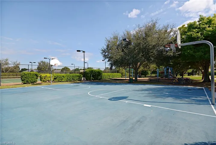 View of basketball court with a playground