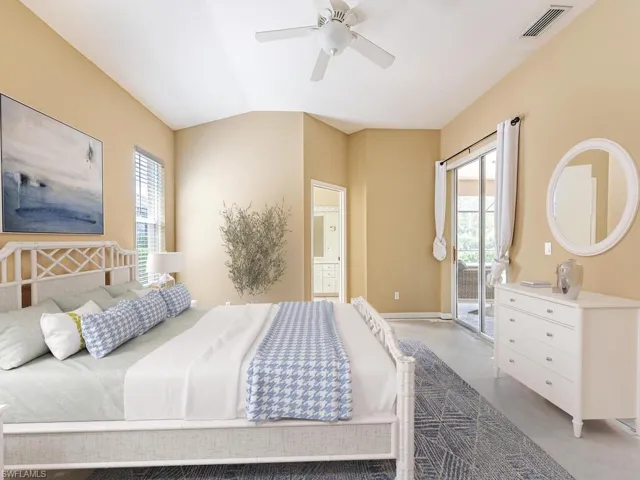 Bedroom with access to exterior, vaulted ceiling, and ceiling fan
