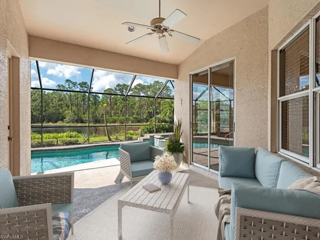 Sunroom / solarium with a pool, vaulted ceiling, and ceiling fan