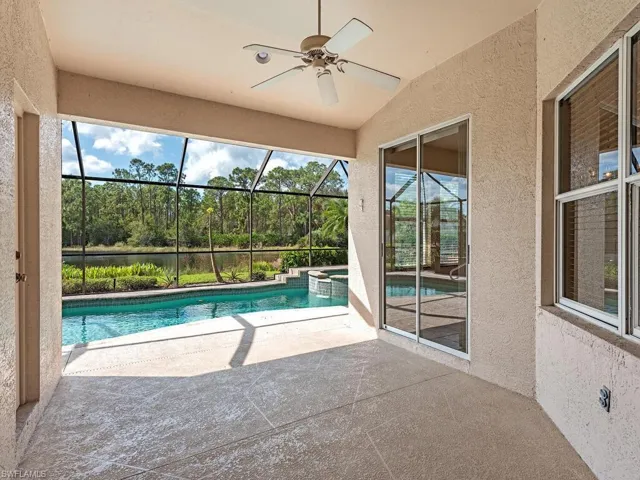 View of pool featuring ceiling fan, a lanai, and a patio area