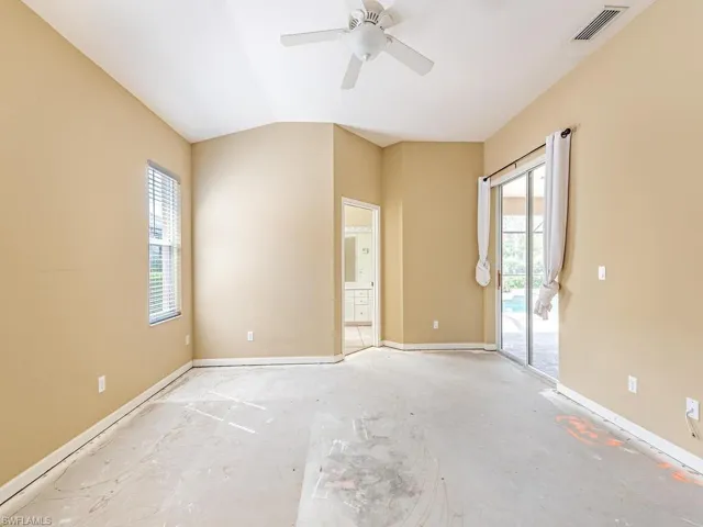Unfurnished room featuring vaulted ceiling and ceiling fan