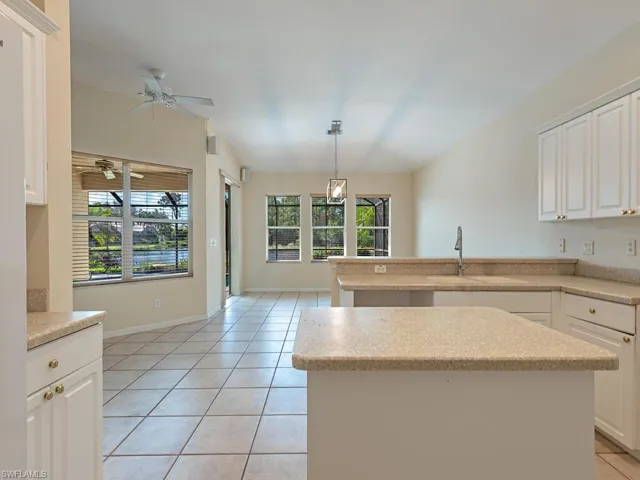 Kitchen with white cabinetry, a healthy amount of sunlight, and a center island