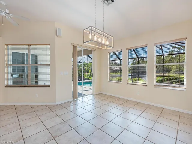 Tiled empty room with ceiling fan
