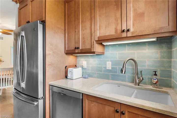 Quartz counters, stainless appliances, rich wood cabinetry, subway tile backsplash!
