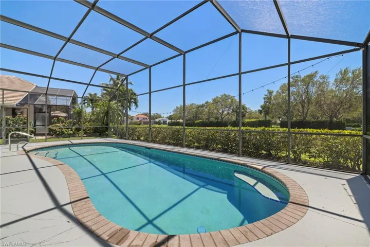 View of pool featuring glass enclosure