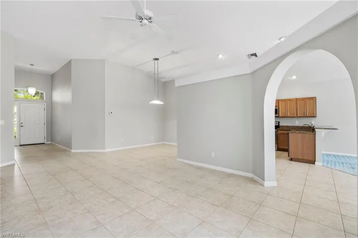 Tiled spare room with sink and ceiling fan