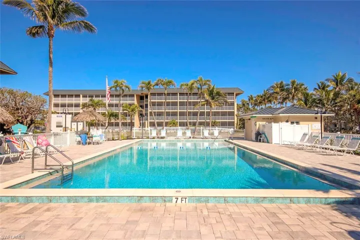 Pool with a patio area and fence