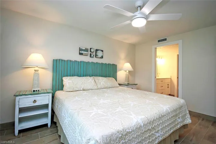 Bedroom featuring visible vents, ceiling fan, and wood tiled floor