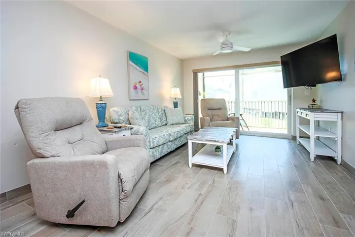Living room featuring wood finish floors and ceiling fan